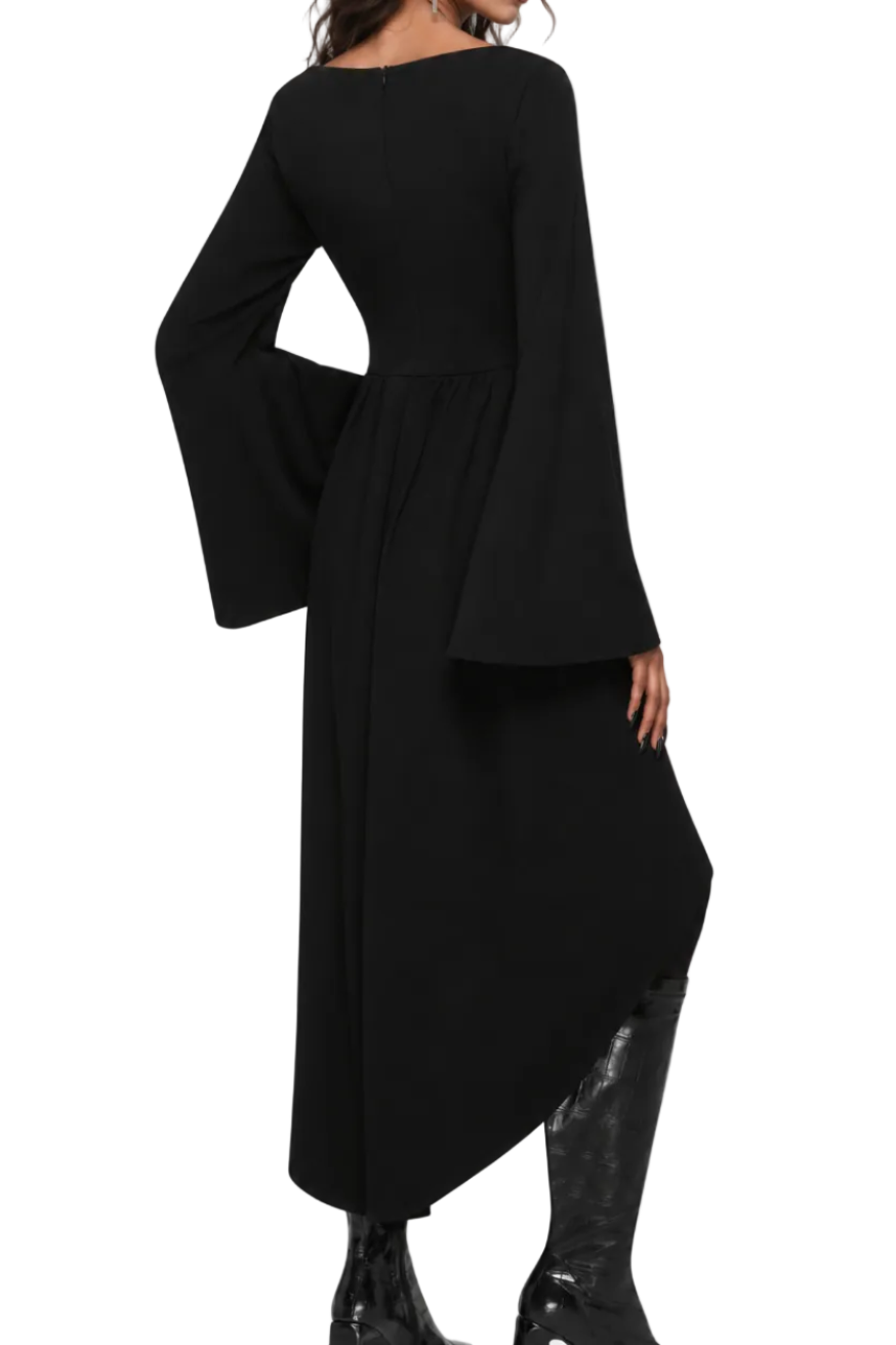 A woman modeling a black long-sleeve midi dress with dramatic bell sleeves and a high-low asymmetrical hem, paired with black knee-high boots against a light gray studio background.